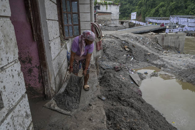 Aftermath of the devastating flash floods in Nepal NUWAKOT, NEPAL - SEPTEMBER 15: A woman clears mud following the devastating flash floods on August 26 that struck Devighat, Nuwakot, Nepal, on September 15, 2026. People in the affected areas of Nuwakot continue to return in search of their destroyed homes and the last remaining memories of their lives. Some are trying to recover essential belongings from the rubble, while others are working with family members to remove soil from parts of their homes buried underground and make them habitable again. The destruction in Devighat village is severe. Many multi-storey buildings have collapsed, while some have been buried under earth up to the level of their fifth floors. Religious figures are a  Copyright: x2026xAnadoluxAbdulxGonix