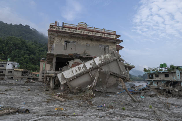 Aftermath of the devastating flash floods in Nepal NUWAKOT, NEPAL - SEPTEMBER 15: A view of the submerged landscape following the devastating flash floods on August 26 that struck Devighat, Nuwakot, Nepal, on September 15, 2026. People in the affected areas of Nuwakot continue to return in search of their destroyed homes and the last remaining memories of their lives. Some are trying to recover essential belongings from the rubble, while others are working with family members to remove soil from parts of their homes buried underground and make them habitable again. The destruction in Devighat village is severe. Many multi-storey buildings have collapsed, while some have been buried under earth up to the level of their fifth floors. Religiou  Copyright: x2026xAnadoluxAbdulxGonix