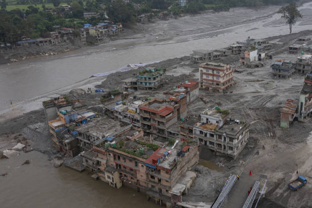 Aftermath of the devastating flash floods in Nepal NUWAKOT, NEPAL - SEPTEMBER 15: A view of the submerged landscape following the devastating flash floods on August 26 that struck Devighat, Nuwakot, Nepal, on September 15, 2026. People in the affected areas of Nuwakot continue to return in search of their destroyed homes and the last remaining memories of their lives. Some are trying to recover essential belongings from the rubble, while others are working with family members to remove soil from parts of their homes buried underground and make them habitable again. The destruction in Devighat village is severe. Many multi-storey buildings have collapsed, while some have been buried under earth up to the level of their fifth floors. Religiou  Copyright: x2026xAnadoluxAbdulxGonix