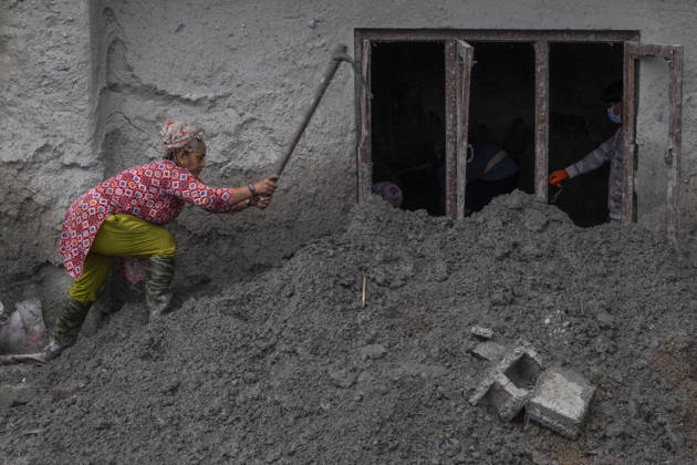 Aftermath of the devastating flash floods in Nepal NUWAKOT, NEPAL - SEPTEMBER 15: A woman clears mud following the devastating flash floods on August 26 that struck Devighat, Nuwakot, Nepal, on September 15, 2026. People in the affected areas of Nuwakot continue to return in search of their destroyed homes and the last remaining memories of their lives. Some are trying to recover essential belongings from the rubble, while others are working with family members to remove soil from parts of their homes buried underground and make them habitable again. The destruction in Devighat village is severe. Many multi-storey buildings have collapsed, while some have been buried under earth up to the level of their fifth floors. Religious figures are a  Copyright: x2026xAnadoluxAbdulxGonix