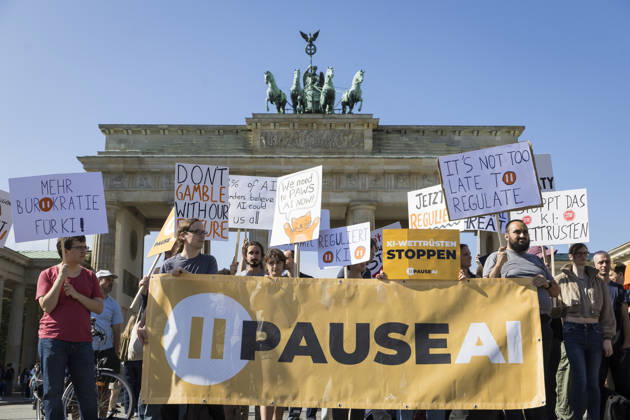Pause AI, Demonstration in front of the Brandenburg Gate, Berlin, September 15, 2026: Members holding signs calling for a pause in AI development during a demonstration by the Pause AI movement in front of the Brandenburg Gate, Berlin, September 15, 2026. Berlin, Brandenburg Gate Copyright: xBenxKriemannx
