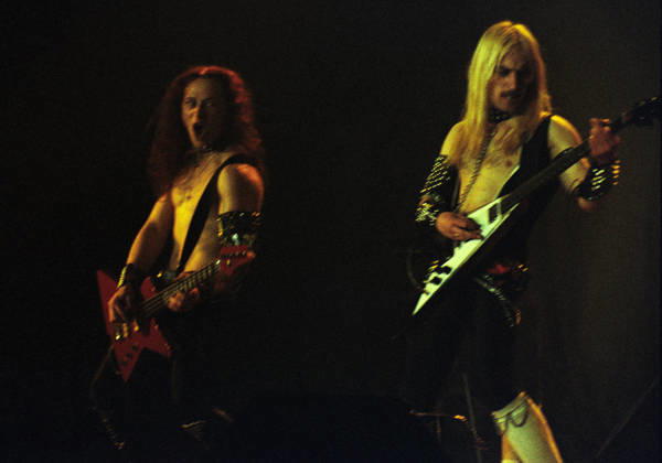 **FILE PHOTO** Conrad Cronos Lant Has Passed Away. LONG ISLAND, NY APRIL 3,1981: Conrad Cronos Lant and Jeffrey Mantas Dunn of Venom perform at North Stage Theater on April 3, 1981 in Long Island, New York. Copyright: xmpi04x