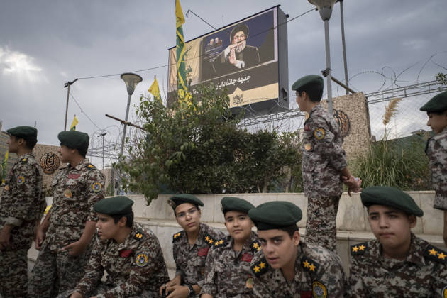 Opening Ceremony Of Second City-Square Military Training Camp Iranian schoolboys wearing military uniforms gather beneath a portrait of Hassan Nasrallah, the late secretary general of Lebanon s Hezbollah, as they prepare to take part in the opening ceremony of the second city-square military training camp for self-sacrificing forces in downtown Tehran, Iran, on October 3, 2026. The camp was established by the Basij paramilitary force, with personnel from the Islamic Republic of Iran Army responsible for training the volunteers. Tehran Tehran Iran Copyright: xMortezaxNikoubazlx originalFilename: nikoubazl-openingc261003_np5QQ