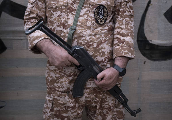 Opening Ceremony Of Second City-Square Military Training Camp A member of the Islamic Revolutionary Guard Corps (IRGC) attaches a badge for self-sacrificing forces to his uniform while holding a rifle and standing guard during the opening ceremony of the second city-square military training camp in downtown Tehran, Iran, on October 3, 2026. The camp was established by the Basij paramilitary force, with personnel from the Islamic Republic of Iran Army responsible for training the volunteers. Tehran Tehran Iran Copyright: xMortezaxNikoubazlx originalFilename: nikoubazl-openingc261003_npNwq