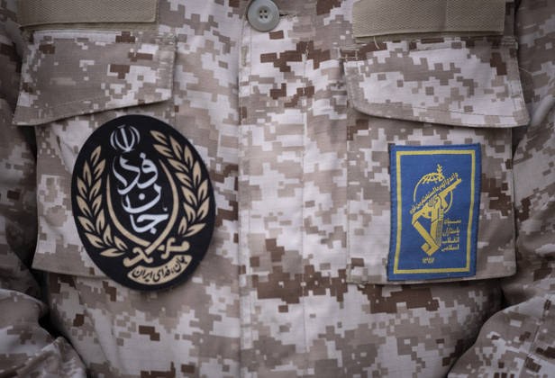 Opening Ceremony Of Second City-Square Military Training Camp A member of the Islamic Revolutionary Guard Corps (IRGC) attaches a badge for self-sacrificing forces to his uniform while standing guard during the opening ceremony of the second city-square military training camp in downtown Tehran, Iran, on October 3, 2026. The camp was established by the Basij paramilitary force, with personnel from the Islamic Republic of Iran Army responsible for training the volunteers. Tehran Tehran Iran Copyright: xMortezaxNikoubazlx originalFilename: nikoubazl-openingc261003_npNZd