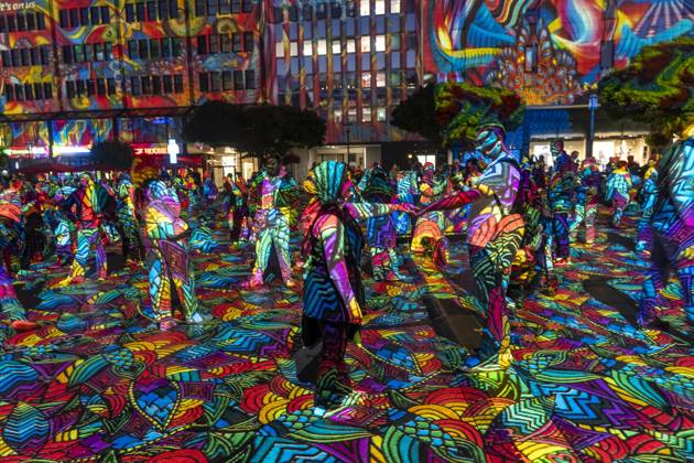 Essen Light Festival, in the city center; the light installation Diving in the Sea of Colors by Berlin-based artist Daniel Margraf illuminates the buildings on the large Kennedy Platz; visitors become part of the light art installation; North Rhine-Westphalia, Germany; Essen Light Festival