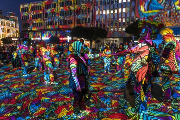 Essen Light Festival, in the city center; the light installation Diving in the Sea of Colors by Berlin-based artist Daniel Margraf illuminates the buildings on the large Kennedy Platz; visitors become part of the light art installation; North Rhine-Westphalia, Germany; Essen Light Festival