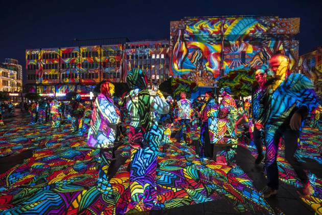 Essen Light Festival, in the city center; the light installation Diving in the Sea of Colors by Berlin-based artist Daniel Margraf illuminates the buildings on the large Kennedy Platz; visitors become part of the light art installation; North Rhine-Westphalia, Germany; Essen Light Festival