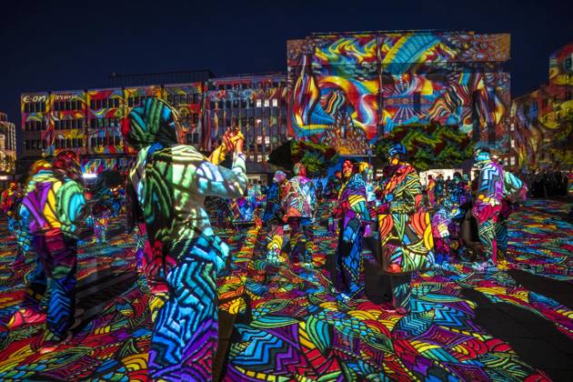 Essen Light Festival, in the city center; the light installation Diving in the Sea of Colors by Berlin-based artist Daniel Margraf illuminates the buildings on the large Kennedy Platz; visitors become part of the light art installation; North Rhine-Westphalia, Germany; Essen Light Festival