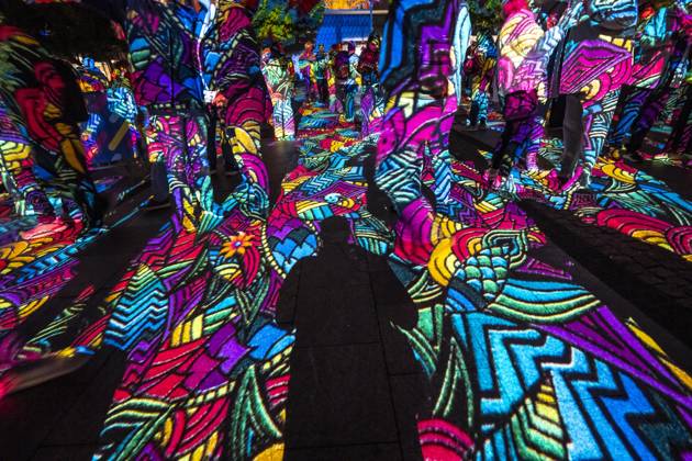 Essen Light Festival, in the city center; the light installation Diving in the Sea of Colors by Berlin-based artist Daniel Margraf illuminates the buildings on the large Kennedy Platz; visitors become part of the light art installation; North Rhine-Westphalia, Germany; Essen Light Festival