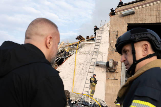 October 5, 2026, Kharkiv, Kharkiv Oblast, Ukraine: Local rescue workers, firefighters and Red Cross volunteers clear rubble following a Russian aerial attack on a bus repair warehouse which killed two people in Kharkiv, Ukraine. Emergency crews search through the heavily damaged building and collapsed sections of the warehouse for survivors and the remains of those killed in the attack. Kharkiv Ukraine - ZUMAm350 20261005_zip_m350_001 Copyright: xCameronxJones-Manleyx