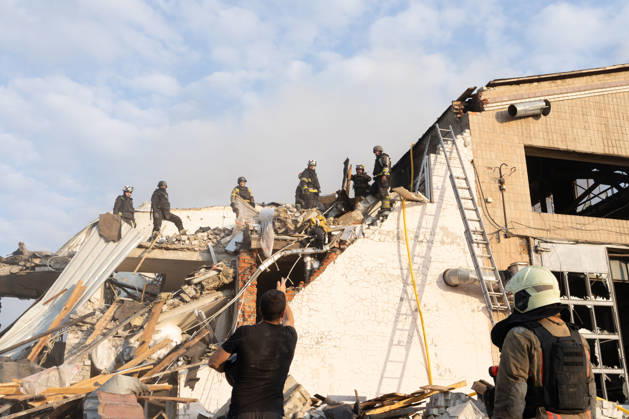 October 5, 2026, Kharkiv, Kharkiv Oblast, Ukraine: Local rescue workers, firefighters and Red Cross volunteers clear rubble following a Russian aerial attack on a bus repair warehouse which killed two people in Kharkiv, Ukraine. Emergency crews search through the heavily damaged building and collapsed sections of the warehouse for survivors and the remains of those killed in the attack. Kharkiv Ukraine - ZUMAm350 20261005_zip_m350_007 Copyright: xCameronxJones-Manleyx