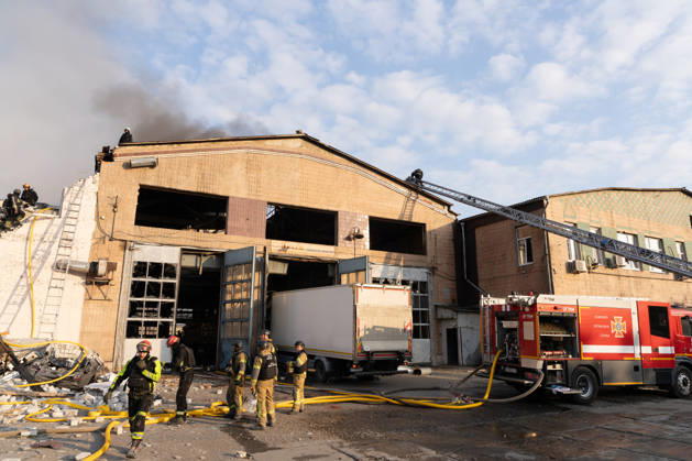 October 5, 2026, Kharkiv, Kharkiv Oblast, Ukraine: Local rescue workers, firefighters and Red Cross volunteers clear rubble following a Russian aerial attack on a bus repair warehouse which killed two people in Kharkiv, Ukraine. Emergency crews search through the heavily damaged building and collapsed sections of the warehouse for survivors and the remains of those killed in the attack. Kharkiv Ukraine - ZUMAm350 20261005_zip_m350_009 Copyright: xCameronxJones-Manleyx