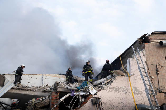 October 5, 2026, Kharkiv, Kharkiv Oblast, Ukraine: Local rescue workers, firefighters and Red Cross volunteers clear rubble following a Russian aerial attack on a bus repair warehouse which killed two people in Kharkiv, Ukraine. Emergency crews search through the heavily damaged building and collapsed sections of the warehouse for survivors and the remains of those killed in the attack. Kharkiv Ukraine - ZUMAm350 20261005_zip_m350_012 Copyright: xCameronxJones-Manleyx