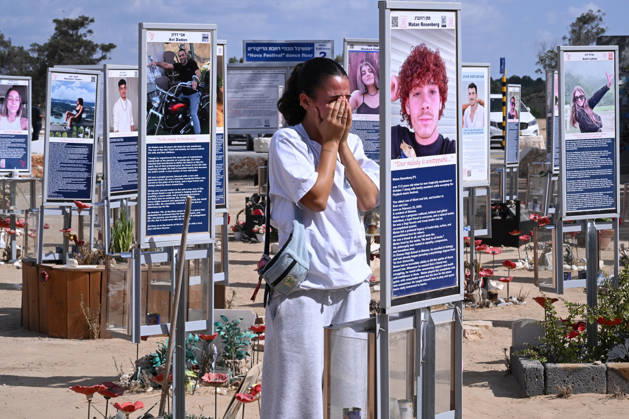 A woman weeps while looking at photos of hundreds of victims killed by Hamas on October 7, 2023, at the Nova Festival Memorial site in Re im, near the Gaza border on Monday, October 6, 2026. Israel is marking three years since the Hamas attack that killed 1,200 people and 251 were taken hostage into Gaza.  JER2026100601 DEBBIExHILL