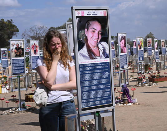 A woman weeps in front of a photo of a victim killed by Hamas on October 7, 2023, at the Nova Festival Memorial site in Re im, near the Gaza border on Monday, October 6, 2026. Israel is marking three years since the Hamas attack that killed 1,200 people and 251 were taken hostage into Gaza.  JER2026100610 DEBBIExHILL
