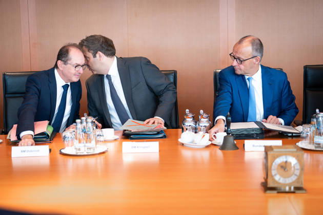 61st Meeting of the Federal Cabinet – Current News, October 7, 2026, Berlin, Chancellor Friedrich Merz (CDU) looks over at Lars Klingbeil, Federal Minister of Finance and Vice Chancellor, and Alexander Dobrindt, Federal Minister of the Interior, who are whispering to each other ahead of the cabinet meeting, a session of the Federal Cabinet at the Federal Chancellery in Berlin, Berlin