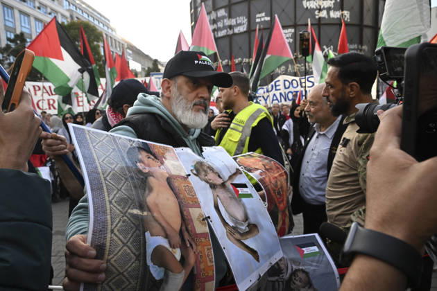 Police in Berlin intervened in demonstrations in support of Palestinians BERLIN, GERMANY - OCTOBER 7: Police officers intervene against a demonstrator carrying photos of Palestinian children killed by Israel in Gaza during a pro-Palestine rally organized by Palestinian associations at the intersection of Zimmer and Friedrich streets in Berlin, Germany on October 7, 2026. Protesters also carried toy dolls wrapped in white shrouds to symbolize the children who lost their lives in Israeli attacks. Halil Sagirkaya Anadolu Berlin Germany. Editorial use only. Please get in touch for any other usage.  Copyright: x2026xAnadoluxHalilxSagirkayax