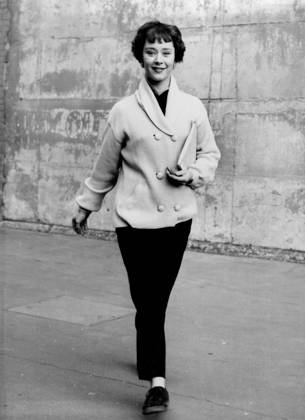 Jane s Studio Rig -- Practical garb for a busy girl in a hurry: Lemon-coloured reefer jacket and black tapered trousers, worn by pretty young actress Jane Griffiths. Jane is seen on the way to lunch at Shepperton Studios, Middlesex, where she has just started work on a new film - The Green Scarf - with Michael Redgrave, Leo Genn and Ann Todd. January 26, 1954. (Photo by Reuterphoto).  Copyright: xP.A.-ReuterxPhotosxLtd.x 5513-78875628