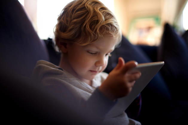 Tablet, child and learning in home with online app, game or watch cartoon to relax. Kid, education and boy with digital technology for development, reading story and streaming video on internet. model released property released Copyright: xx