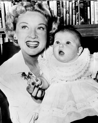 Bonita Granville And Daughter -- Six-months-old Linda Bonita Wrather, who s starting life as the daughter of a movie star and heiress to a Texas oil fortune, seems amazed by the antics of the photographer making her first picture. Mother Bonita Granville and Father Jack Wrather, Texas oil man who became a movie producer, left for a European tour shortly after this picture was made several days ago. October 13, 1949. (Photo by AP Wirephoto).  Copyright: xAPxWirephotox 5513-78877888