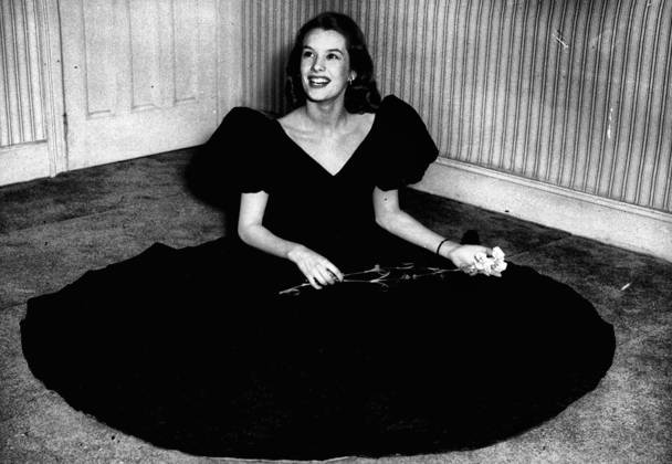 Star in Black for are Birthday Nylon Flown from America -- British Film Star Sally Ann Howes in the Special Cocktail Ensemble Which she wore at her 21st Birthday Party in London Today. It was Specially Created for her By Herbert Sidon and was in Black Nylon Cloque Specially flown from America and Features Large Puff Sleeves. July 20, 1951. (Photo by Paul Popper)  Copyright: xPaulxPopperx 5513-85305230
