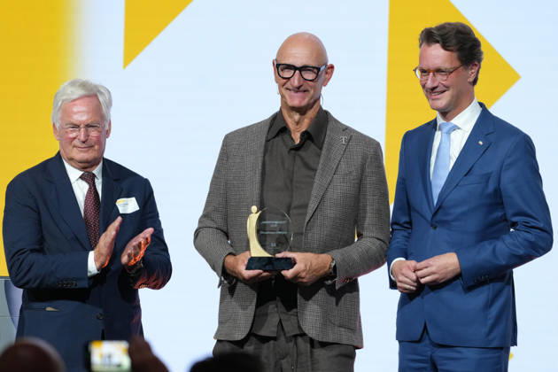 Brand Economy Day 2026: Franz Peter Falke on stage with Tim Hoettges, CEO of Telekom and winner of the Human Brand award, and Hendrik Wuest, Minister President of North Rhine-Westphalia, at Brand Economy Day 2026, Berlin, October 8, 2026, Berlin, Berlin, Germany