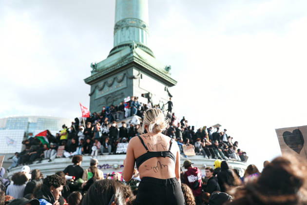 High School And University Student Protest - Paris A protester at Place de la Bastille, in front of the July Column with the inscription macron, fuck your mother on her back, during a nationwide youth demonstration. Nationwide mobilization by high school and university students calling for better teaching and study conditions, increased funding and staffing, an end to overcrowded classrooms and deteriorating infrastructure, and improved access to education, amidst concerns over social inequalities and student financial insecurity in Paris, France, October 8, 2026. Photo by Christophe Michel ABACAPRESS.COM Paris ILE DE FRANCE France Copyright: xMichelxChristophe ABACAx