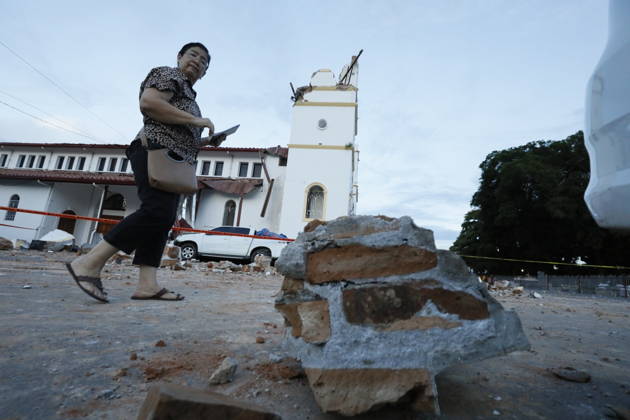 (261010) -- PANAMA CITY, Oct. 10, 2026 -- A woman walks near a collapsed bell tower of a church after a strong earthquake in Penonome, central Cocle Province of Panama. A powerful earthquake and a series of strong aftershocks rattled Panama on Friday, sending residents into the streets, disrupting water supplies and briefly halting flights as the government mobilized emergency personnel and resources. The University of Panama s Institute of Geosciences measured the initial quake at magnitude 7.2. It struck at 12:56 p.m. local time (1756 GMT) at a depth of 4 kilometers. By 5:30 p.m. local time, more than 40 earthquakes had been recorded, including over a dozen with magnitudes above 5.0. A quake at 3:25 p.m. had a magnitude of 6.9. (Photo 