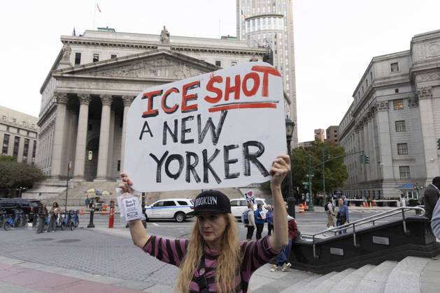 October 9, 2026, New York, New York, USA: A demonstrator holds a sign that reads ICE SHOT A NEW YORKER. Thousands of people join the Hands Off NYC coalition at a rally outside Federal Plaza in Lower Manhattan before marching through the streets for an emergency protest demanding justice the day following ICE shooting a Bronx man while his 5 year child was in the car. New York USA  - ZUMAr174 20261009_znp_r174_011 Copyright: xGinaxMxRandazzox