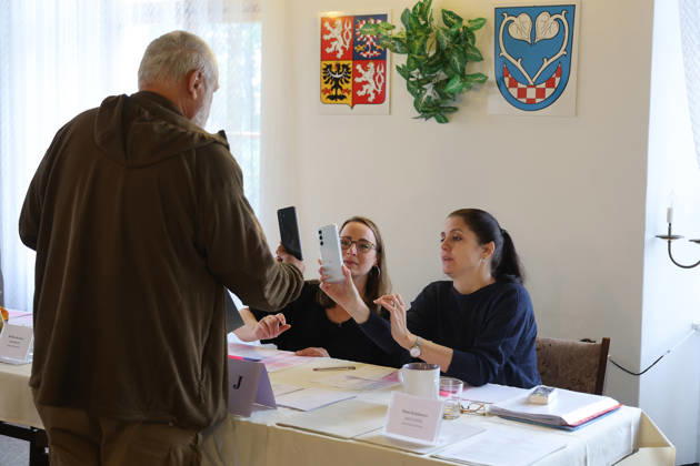 The two-day elections to municipal assemblies continued in the Czech Republic together with the first round of the elections to one-third of the Senate, on October 10, 2026. On the photo: alongside the municipal and senate elections a referendum on the extraction of remaining reserves at the former Mladecko quarry, in Litultovice, Moravian-Silesian Region. On the photo a voter identifies himself at a polling station using the eDoklady app (digital ID copy) on his mobile phone before casting his vote. (CTKxPhoto PetrxSznapka) CTKPhotoP2026101002467  CTKPhotoP2026101002467