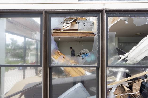 October 10, 2026, Pensacola Beach, Fl, USA: Alex Dean cleans out his home that was severely damaged during Hurricane Isaias..Hurricane Isaias made landfall Friday, October 9 along the U.S. Gulf coast. Pensacola Beach USA - ZUMAs197 20261010_aaa_s197_030 Copyright: xJenxGolbeckx