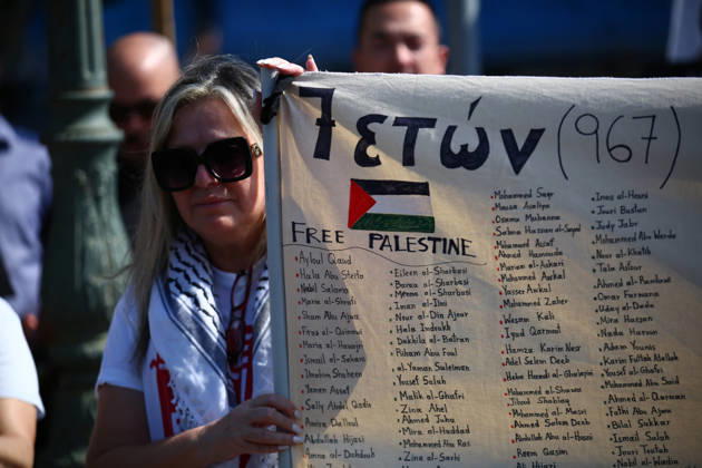 October 10, 2026, Athens, Attica, GREECE: A woman holds a banner bearing the names of Palestinians children killed in Gaza during a pro-Palestinian demonstration. Athens GREECE  - ZUMAx103 20261010_zip_x103_002 Copyright: xHarrisxXanthopoulosx