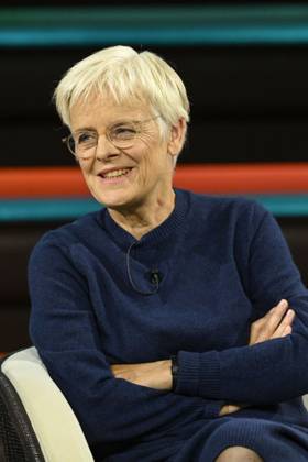Ulrike Herrmann, journalist, 10 26. Ulrike Herrmann appeared on Markus Lanz on October 8, 2026, on ZDF TV, a German talk show. German female journalist, journalism, *taz*, sitting upright, smiling, arms crossed.