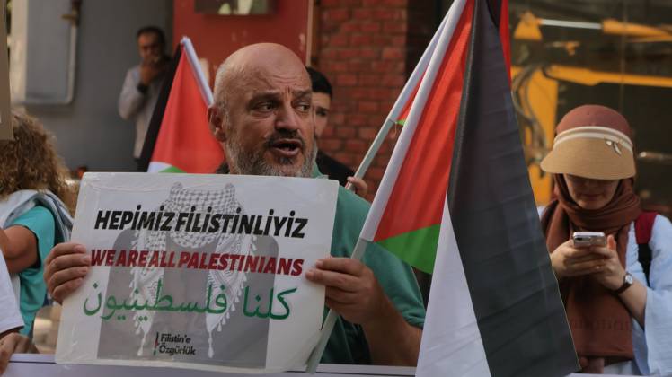 October 11, 2026, Â°Zmir, ToÂ¼rkiye: IZMIR, TURKEY, OCTOBER 11, 2026: Pro-Palestinian demonstrators gather outside the Turkan Saylan Cultural Center in Izmir during a protest organized by the local branch of the Association for the Freedom of Palestinians. Participants condemn Israeli military operations in Gaza and criticize US support for Israel, calling attention to Palestinian civilian casualties since October 7, 2023. The demonstration concludes at Gundogdu Square, where participants throw carnations into the sea in remembrance of Palestinians killed during the conflict. Â°Zmir Türkiye - ZUMAq101 20261011_zna_q101_108 Copyright: xTurgayxKilicx