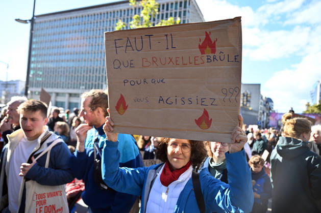 Tens of thousands march in Brussels demanding stronger climate action BRUSSELS, BELGIUM - OCTOBER 11: Demonstrators hold climate-themed placards as tens of thousands of people march through Brussels calling for stronger action against climate change and reduced dependence on fossil fuels, on October 11, 2026 in Brussels, Belgium. The protest was organized by the Belgian Climate Coalition, which brings together around 100 civil society organizations. Participants marched along major roads toward Schuman Square, home to several European Union institutions, while protesting the government s climate policies. Dursun Aydemir Anadolu Brussels Belgium. Editorial use only. Please get in touch for any other usage.  Copyright: x2026xAnadoluxDursunxAydemirx