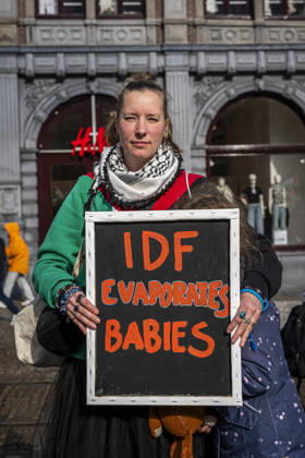 October 11, 2026, Amsterdam, North Holland, The Netherlands - Holland: 11 October 2026, Amsterdam, the Netherlands: A Protester holds a sign reading Ã¢â‚¬oeIDF Evaporates BabiesÃ¢â‚¬Â. Protesters gathered at Dam Square for speeches and anti-war music before marching through AmsterdamÃ¢â‚¬â ¢s city centre in a demonstration dubbed Ã¢â‚¬oeThree Years of GenocideÃ¢â‚¬Â. The event marked three years since the start of the IsraelÃ¢â‚¬Hamas war. Demonstrators carried Palestinian flags and banners, demanding the Dutch government act against what they describe as a genocide in Gaza. Amsterdam The Netherlands - Holland - ZUMAp202 20261011_zip_p202_004 Copyright: xJamesxPetermeierx