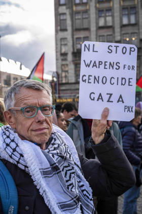 October 11, 2026, Amsterdam, North Holland, The Netherlands - Holland: 11 October 2026, Amsterdam, the Netherlands: A Protester holds a sign reading Ã¢â‚¬oeNL Stop Weapons for Genocide GazaÃ¢â‚¬Â (translated from Dutch). Protesters gathered at Dam Square for speeches and anti-war music before marching through AmsterdamÃ¢â‚¬â ¢s city centre in a demonstration dubbed Ã¢â‚¬oeThree Years of GenocideÃ¢â‚¬Â. The event marked three years since the start of the IsraelÃ¢â‚¬Hamas war. Demonstrators carried Palestinian flags and banners, demanding the Dutch government act against what they describe as a genocide in Gaza. Amsterdam The Netherlands - Holland - ZUMAp202 20261011_zip_p202_014 Copyright: xJamesxPetermeierx