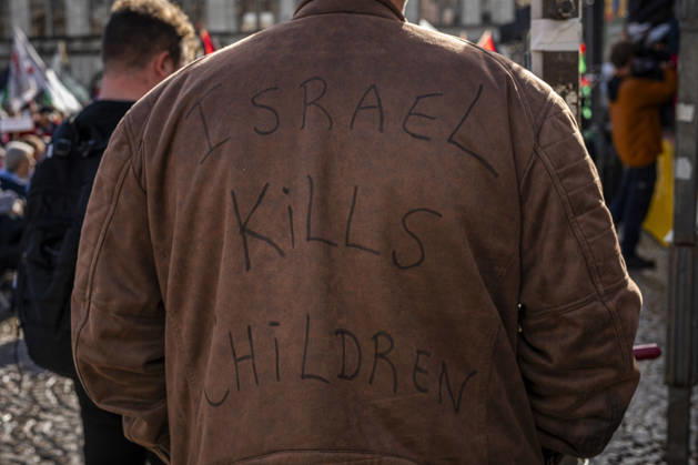 October 11, 2026, Amsterdam, North Holland, The Netherlands - Holland: 11 October 2026, Amsterdam, the Netherlands: A protester wears a jacket baring the words Ã¢â‚¬oeIsrael Kills Children.Ã¢â‚¬Â Protesters gathered at Dam Square for speeches and anti-war music before marching through AmsterdamÃ¢â‚¬â ¢s city centre in a demonstration dubbed Ã¢â‚¬oeThree Years of GenocideÃ¢â‚¬Â. The event marked three years since the start of the IsraelÃ¢â‚¬Hamas war. Demonstrators carried Palestinian flags and banners, demanding the Dutch government act against what they describe as a genocide in Gaza. Amsterdam The Netherlands - Holland - ZUMAp202 20261011_zip_p202_017 Copyright: xJamesxPetermeierx