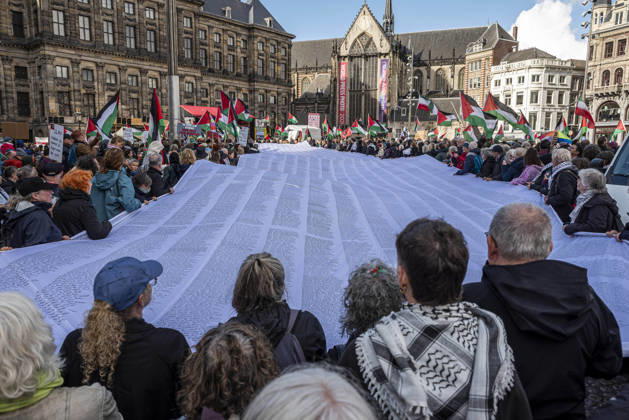 October 11, 2026, Amsterdam, North Holland, The Netherlands - Holland: 11 October 2026, Amsterdam, the Netherlands: Protesters hold a banner baring the names of thousands of people killed in Gaza. Protesters gathered at Dam Square for speeches and anti-war music before marching through AmsterdamÃ¢â‚¬â ¢s city centre in a demonstration dubbed Ã¢â‚¬oeThree Years of GenocideÃ¢â‚¬Â. The event marked three years since the start of the IsraelÃ¢â‚¬Hamas war. Demonstrators carried Palestinian flags and banners, demanding the Dutch government act against what they describe as a genocide in Gaza. Amsterdam The Netherlands - Holland - ZUMAp202 20261011_zip_p202_019 Copyright: xJamesxPetermeierx