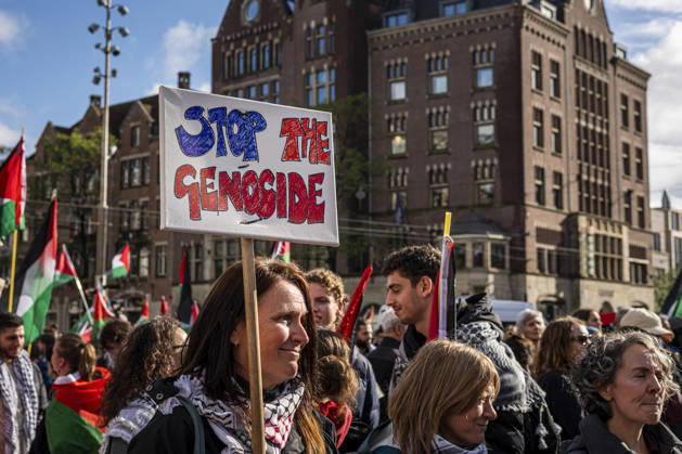 October 11, 2026, Amsterdam, North Holland, The Netherlands - Holland: 11 October 2026, Amsterdam, the Netherlands: Protesters gathered at Dam Square for speeches and anti-war music before marching through AmsterdamÃ¢â‚¬â ¢s city centre in a demonstration dubbed Ã¢â‚¬oeThree Years of GenocideÃ¢â‚¬Â. The event marked three years since the start of the IsraelÃ¢â‚¬Hamas war. Demonstrators carried Palestinian flags and banners, demanding the Dutch government act against what they describe as a genocide in Gaza. Amsterdam The Netherlands - Holland - ZUMAp202 20261011_zip_p202_024 Copyright: xJamesxPetermeierx