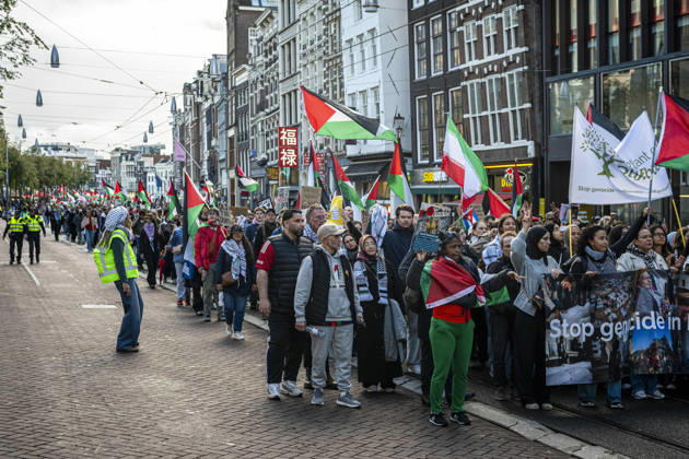 October 11, 2026, Amsterdam, North Holland, The Netherlands - Holland: 11 October 2026, Amsterdam, the Netherlands: Protesters gathered at Dam Square for speeches and anti-war music before marching through AmsterdamÃ¢â‚¬â ¢s city centre in a demonstration dubbed Ã¢â‚¬oeThree Years of GenocideÃ¢â‚¬Â. The event marked three years since the start of the IsraelÃ¢â‚¬Hamas war. Demonstrators carried Palestinian flags and banners, demanding the Dutch government act against what they describe as a genocide in Gaza. Amsterdam The Netherlands - Holland - ZUMAp202 20261011_zip_p202_028 Copyright: xJamesxPetermeierx