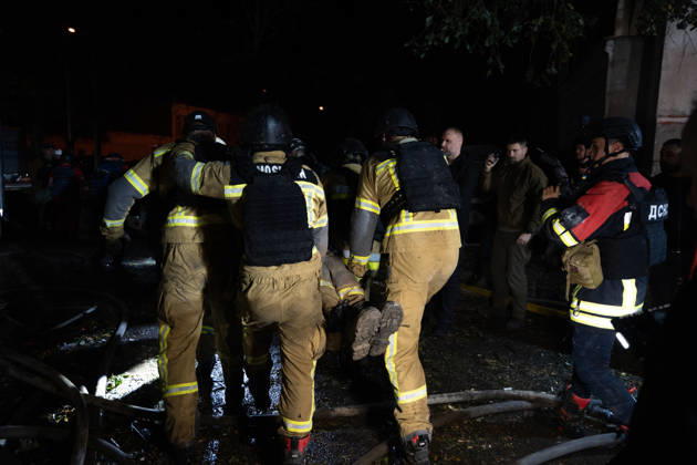 October 12, 2026, Kharkiv, Kharkiv Oblast, Ukraine: Rescuers load an injured firefighter into an ambulance after a sustained injury clearing debris at a Russian cruise missile strike on a residential area in Kharkiv, Ukraine, 2026. Kharkiv Ukraine  - ZUMAm350 20261012_zip_m350_005 Copyright: xCameronxJones-Manleyx
