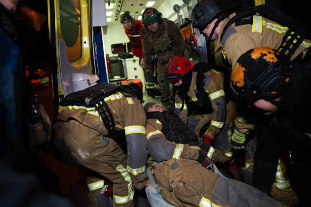 October 12, 2026, Kharkiv, Kharkiv Oblast, Ukraine: Rescuers load an injured firefighter into an ambulance after a sustained injury clearing debris at a Russian cruise missile strike on a residential area in Ukraine. Kharkiv Ukraine - ZUMAm350 20261012_zip_m350_006 Copyright: xCameronxJones-Manleyx