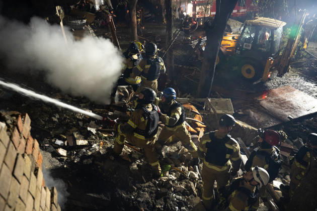 October 12, 2026, Kharkiv, Kharkiv Oblast, Ukraine: Local rescue workers and volunteers clear rubble following a Russian Missile attack on a residential area that killed multiple people in Kharkiv, Ukraine. Emergency crews search through the heavily damaged building and collapsed sections of the building for survivors and the remains of those killed in the attack. Kharkiv Ukraine - ZUMAm350 20261012_zip_m350_015 Copyright: xCameronxJones-Manleyx