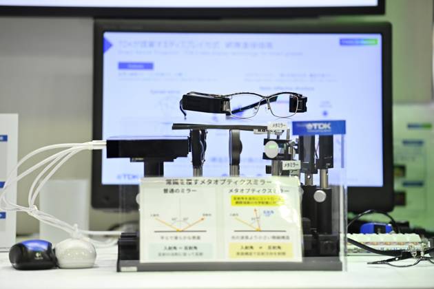 Japan showcases emerging technologies at CEATEC 2026 CHIBA, JAPAN - OCTOBER 13: A prototype of smart glasses incorporating TDK s Meta-Optic Mirror technology is displayed during CEATEC 2026 at Makuhari Messe in Chiba, Japan, October 13, 2026. The 150-nanometer-thick optical mirror is designed to replace bulkier curved mirrors traditionally used in direct retinal projection systems. David Mareuil Anadolu Chiba Japan. Editorial use only. Please get in touch for any other usage.  Copyright: x2026xAnadoluxDavidxMareuilx