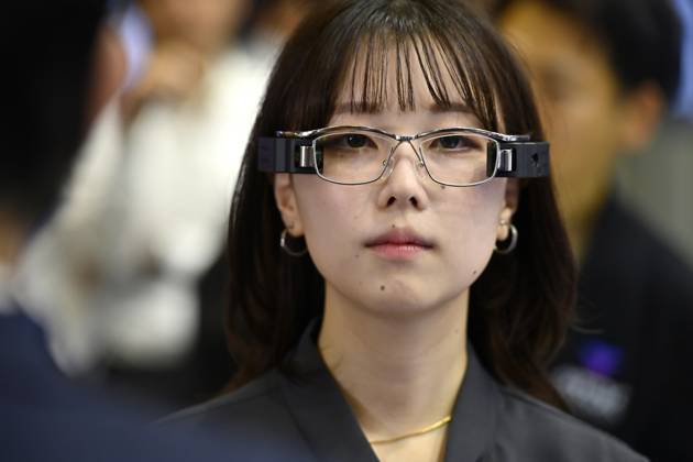 Japan showcases emerging technologies at CEATEC 2026 CHIBA, JAPAN - OCTOBER 13: A visitor tries on a prototype of smart glasses featuring Meta-Optic Mirror technology developed by Japanese electronics company TDK during CEATEC 2026 at Makuhari Messe in Chiba, Japan, October 13, 2026. The prototype uses an ultra-thin optical mirror to direct projected images onto the retina, with TDK aiming to develop more compact and conventional-looking smart glasses. David Mareuil Anadolu Chiba Japan. Editorial use only. Please get in touch for any other usage.  Copyright: x2026xAnadoluxDavidxMareuilx