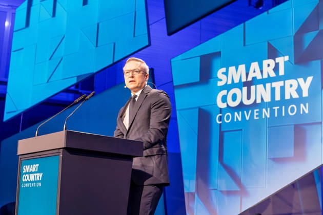 Berlin, 13.10.2026: Bundesdigitalminister Karsten Wildberger spricht am Rednerpult auf der Bühne der Smart Country Convention in der Halle hub27. Karsten Wildberger ist seit Mai 2025 Bundesminister für Digitales und Staatsmodernisierung und leitet das damals neu geschaffene Ministerium, das die Digitalisierung von Staat und Verwaltung bündeln soll; zuvor war der Manager Vorstandschef des Elektronikhändlers Ceconomy (MediaMarkt und Saturn). Die Smart Country Convention (SCCON) ist die Kongressmesse für die Digitalisierung des öffentlichen Sektors und wird vom Digitalverband Bitkom gemeinsam mit der Messe Berlin veranstaltet. Vom 13. bis 15. Oktober 2026 treffen sich in der Halle hub27 Vertreter aus Bund, Ländern und Kommunen mit Unter