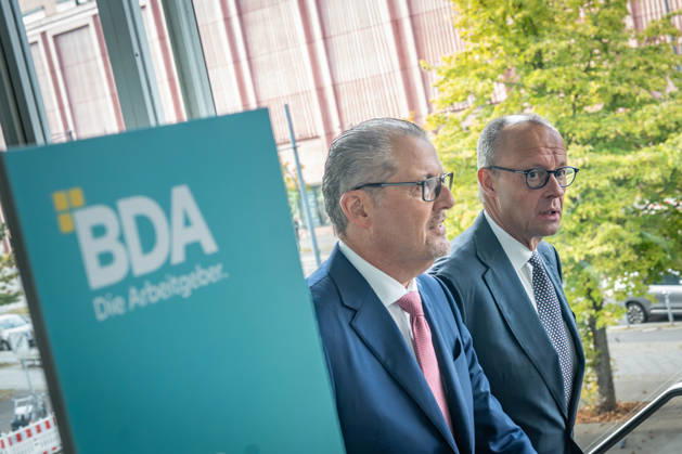 Chancellor Friedrich Merz is welcomed by Rainer Dulger, President of the Confederation of German Employers Associations (BDA), at the start of the 2026 German Employers Day, hosted by the Confederation of German Employers Associations (BDA), Berlin, Germany, at the Berlin Congress Center (bcc)