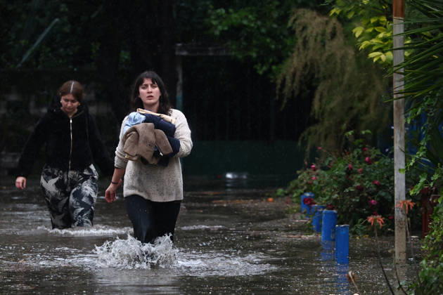 Chile declares a red alert in Santiago following heavy hailstorm SANTIAGO, CHILE - OCTOBER 13: Residents evacuate their inundated homes after heavy rain and hail battered Santiago, Chile, on October 13, 2026. The severe storm flooded residential neighborhoods and submerged streets, prompting local authorities to declare a red alert across the capital as emergency crews assisted in evacuating affected areas. Lucas Aguayo Araos Anadolu Santiago Chile. Editorial use only. Please get in touch for any other usage.  Copyright: x2026xAnadoluxLucasxAguayoxAraosx